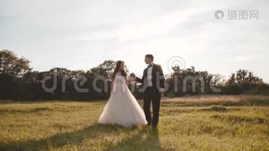 幸福的新婚夫妇在美丽的大自然上散步和旋转视频