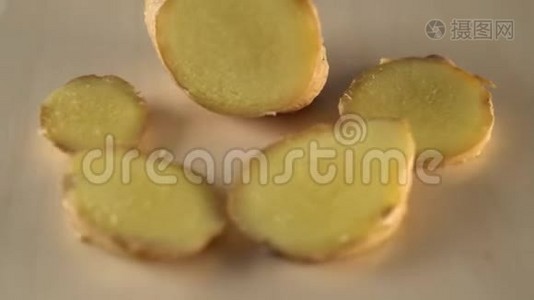 姜根在木制表面旋转的多汁熟片视频