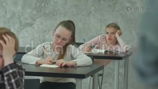 穿校服的学生在教室的课桌上参加考试视频