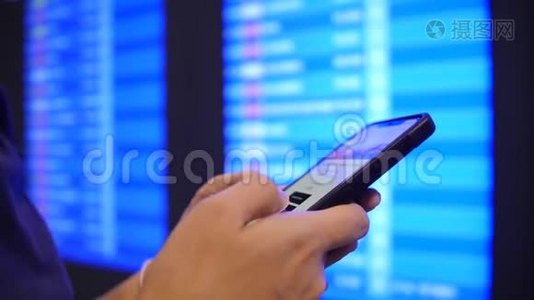 旅游妇女使用手机在机场离港板附近检查她的航班时间。 4K慢动作。 泰国曼谷。视频