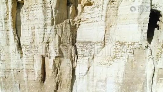 斜坡中部的浮雕白崖坡和大型石窟的特写。 中枪。 雄伟的山崖视频
