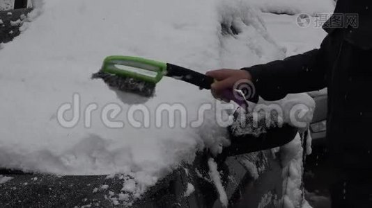 男人用手把车上的雪擦干净视频