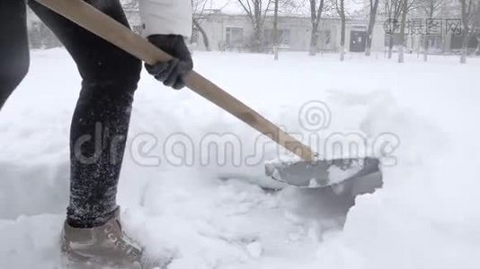 冬天的工作，人们用铁锹在下雪的时候打扫庭院视频