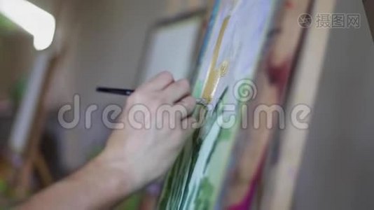 艺术家画油漆刷的图片.. 男性艺术家手中的画笔。 艺术观念。 特写绘画画面视频