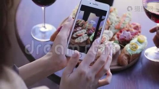 餐饮拍照.. 女人看手机屏幕上的照片视频