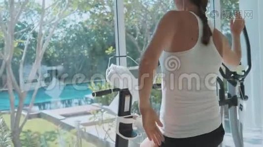 在健身馆里骑着静止的自行车慢动作的特写女性脚视频