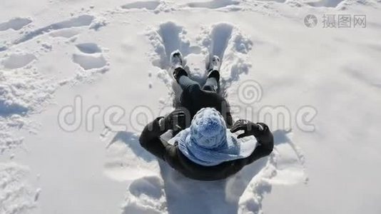 女孩戴着蓝帽子躺在雪地上视频