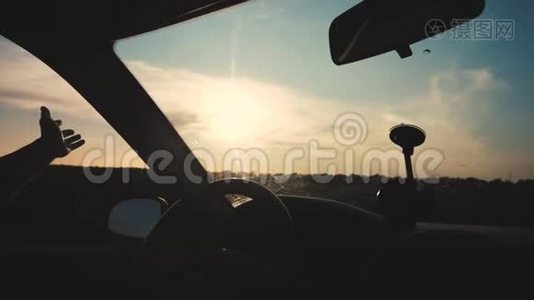 旅行自由概念。 慢动作视频。 司机的手在一个背景的车窗上玩太阳视频