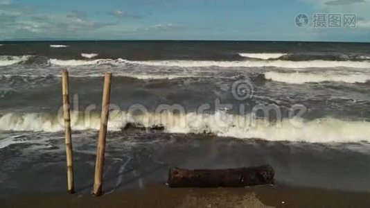 竹竿前景，海水被微风吹进海滩视频