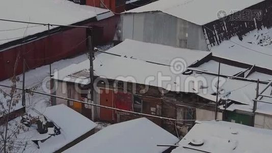 冬季日落时，莫斯科的车库合作区的旧消声器店被雪覆盖到大宿舍区。视频