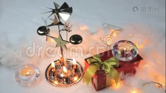 用蜡烛和礼物合上圣诞灯笼的电影。 白色毛皮上的圣诞装饰。视频