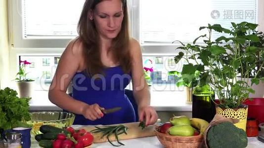 厨房里的孕妇用洋葱和有机蔬菜做新鲜沙拉视频