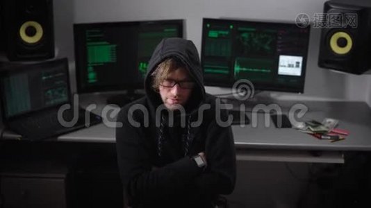 黑客思考他的黑客程序，然后突然转向监视器屏幕，开始工作。 他穿着视频