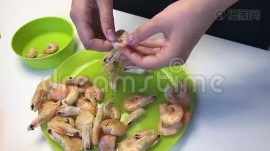 女人清理煮虾。 桌子上的下一个是蔬菜和豆腐块。视频