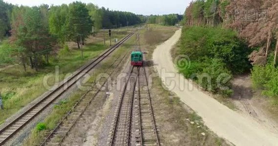 小火车头沿着森林里的铁路行驶，绿色火车头沿着森林路空中行驶视频