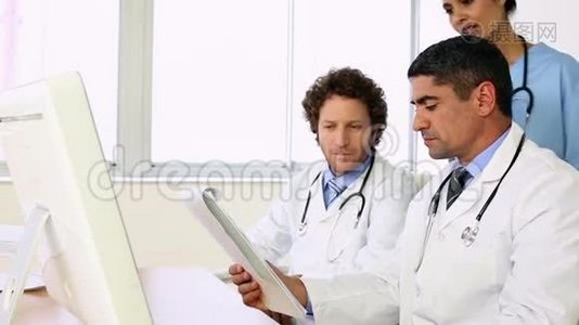 坐在办公桌前的医生和护士谈论xray视频