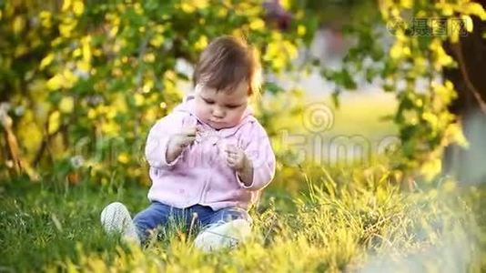 日落时分，坐在公园草地上的漂亮小女孩视频