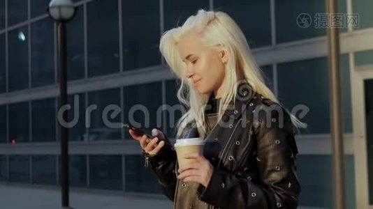 一位年轻时尚的女士在城市街道上的日落咖啡电话视频