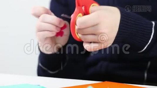 女孩用手从彩纸上剪花做工艺品视频