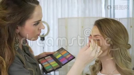 化妆师准备模特在美容店展示。 化妆师专业做化妆..视频