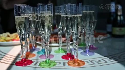 在一张桌子上排着一排排的香槟酒，等待着婚宴的客人视频
