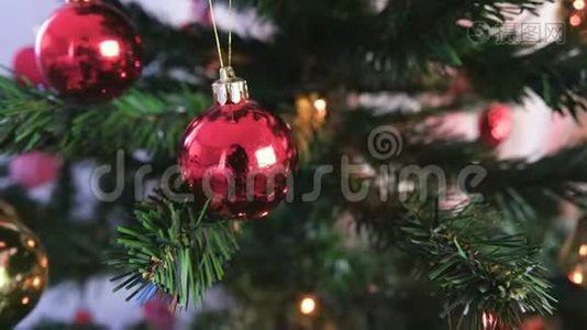 圣诞树上有红色闪亮的球。 圣诞树上有灯光的圣诞花环视频
