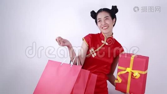 女人手里拿着购物袋和红色礼盒，概念中国新年庆典视频