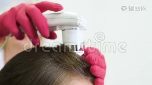 皮肤科医生诊断一个年轻漂亮女孩的头发结构与一个特殊的工具-一个旋毛镜。视频
