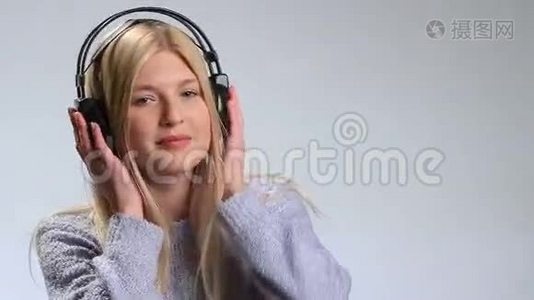 情绪化的女孩在耳机里享受音乐视频