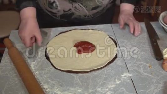 准备自制比萨饼在一个轻厨房的桌子上，特写镜头。视频