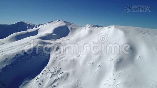 在白天阳光照耀下的绿松石雪山上空飞行视频