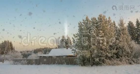 森林附近的一个小木屋，夕阳下一场美丽的降雪，一道美丽的冬季景观.. 视频循环视频