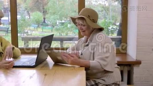 两名老年妇女和笔记本电脑。视频