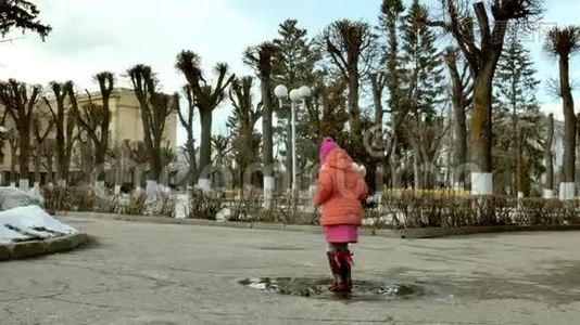 雨后小女孩在水坑上跳视频