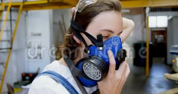 4k车间佩戴防毒面具的女焊工视频