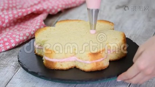糕点厨师正在做一个粉红色的蛋糕，形状像一朵花。 系列。视频
