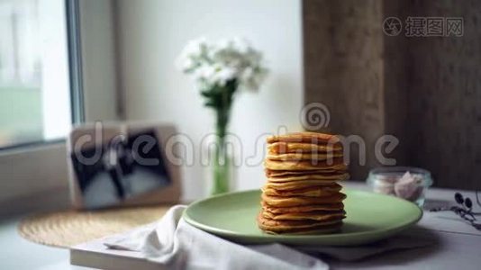 女人把煎饼放在煎饼堆上。 煎饼早餐视频