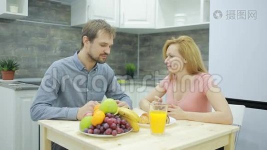 厨房里的年轻夫妇。 喝茶吃水果视频