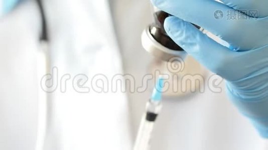 医生双手戴防护手套，用药物填充注射器。视频