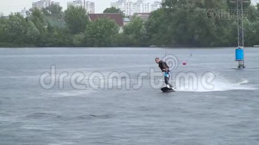 穿着潜水衣的帅哥正在河上骑着一辆尾板视频