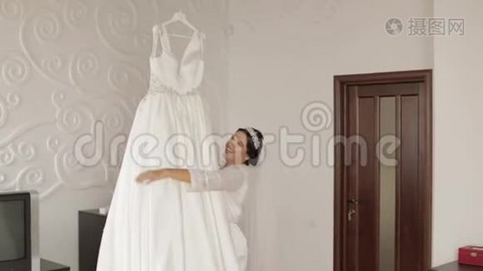 美丽可爱的新娘穿着睡衣和面纱。 结婚礼服。 慢动作视频