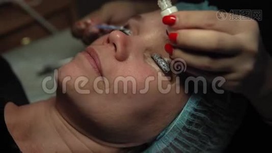 女人在卷曲和角蛋白睫毛提升程序。视频