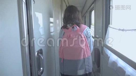 十几岁的女孩走在火车车厢里，带着生活方式和背包。 交通运输铁路概念视频