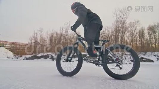 专业的极限运动员骑自行车在户外骑胖自行车。 后轮的近距离观察。 冬天骑自行车视频