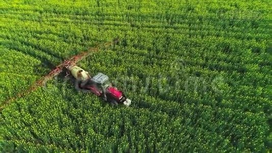 农用拖拉机耕田喷洒的鸟瞰图。视频
