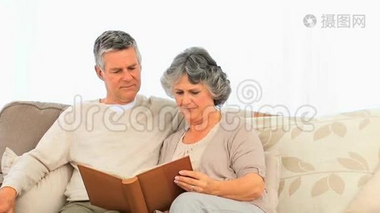 年长夫妇正在看他们的相册视频
