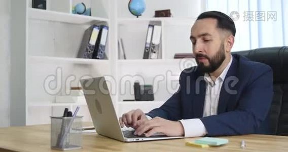 在办公室里用手提电脑工作的商人视频