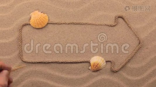 用手写在沙子上的沙滩铭文，用绳子做成的指针。视频