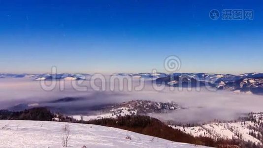 冬天，雾以星状的天空在山上移动视频