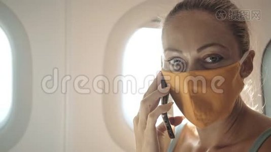 女旅游白种人在飞机上戴着防护医疗面罩。 阅读有关鸡冠状病毒的震惊新闻视频